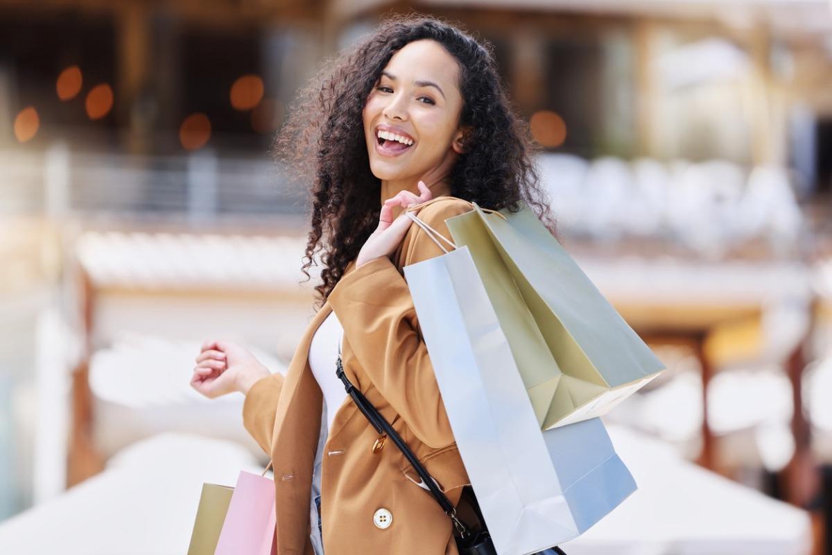 Smiling woman carrying shopping backs during Black Friday sales in Myrtle Beach.