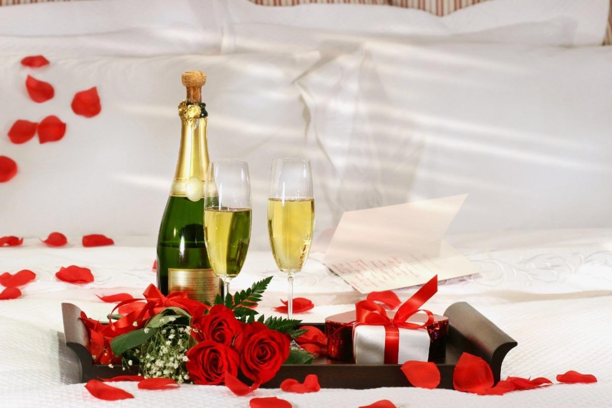 a romantic package in a vacation rental with rose petals and champagne.